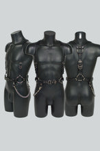 Load image into Gallery viewer, Three black leather harnesses on mannequins against a gray background