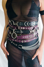 Load image into Gallery viewer, Person wearing multiple belts with metallic hardware on a plain background